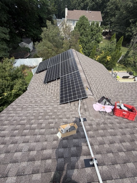 Solar panels being installed with tools and equipment on roof
